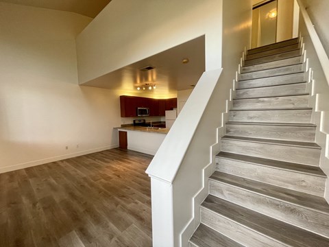 a view from the top of the stairs looking into the kitchen and living room a view from the top of the stairs looking into the kitchen and living room  at Polo Villas, Bakersfield, CA